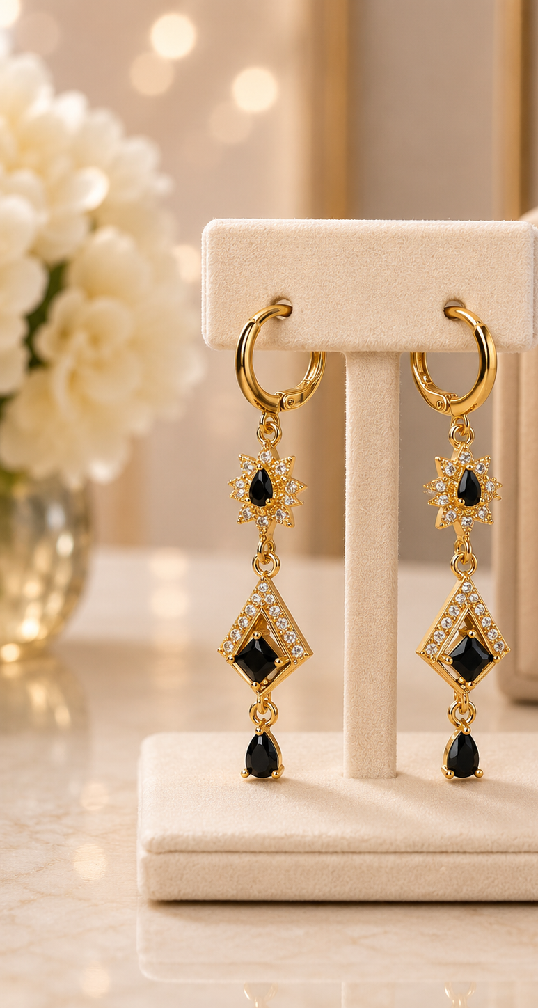 Gold earrings with black gemstone
