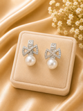 Pearl earrings with silver bows